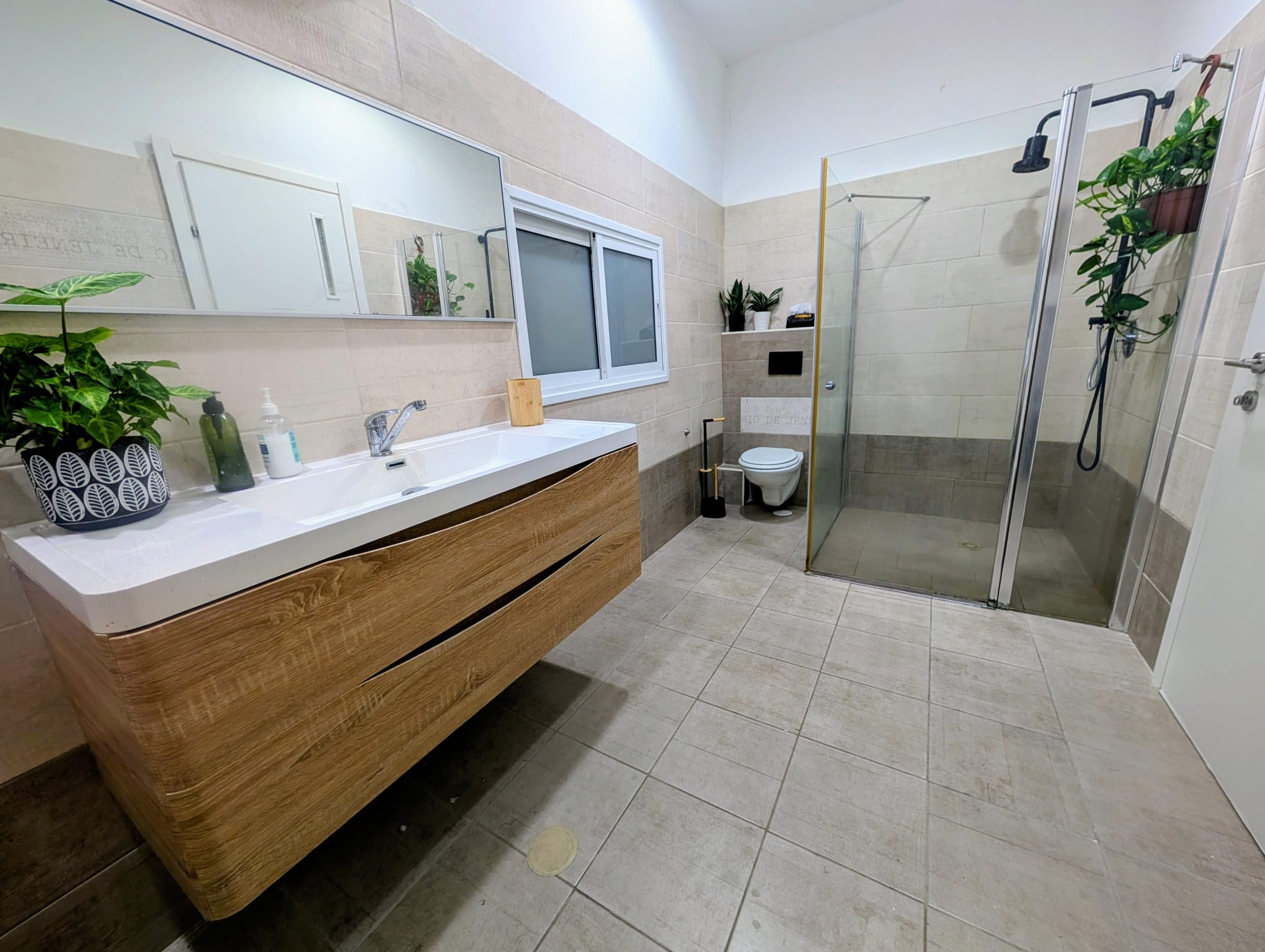 Wide bathroom with shower and vanity